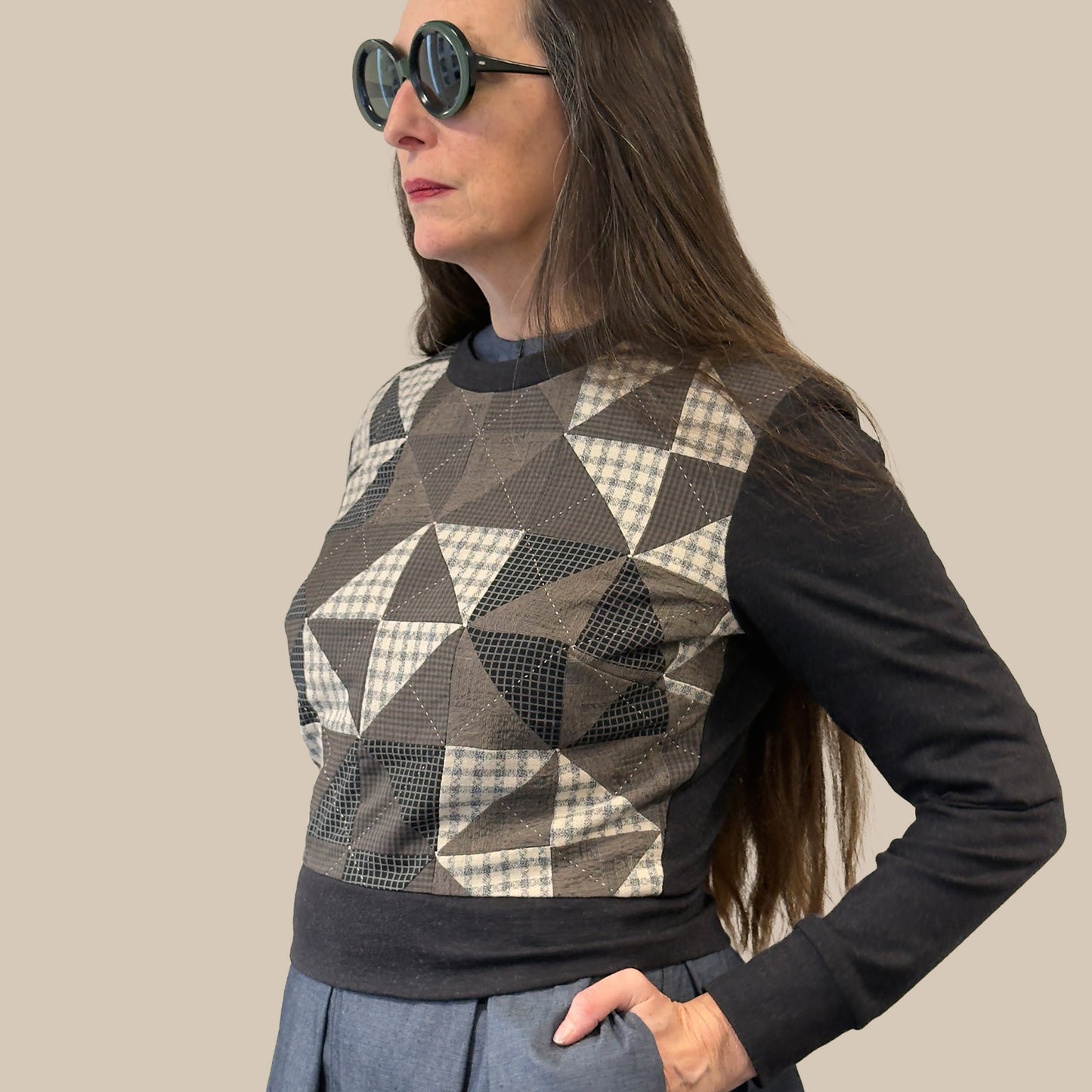 Ladies cropped merino wool sweater with hand pieced and quilted front panel, side view