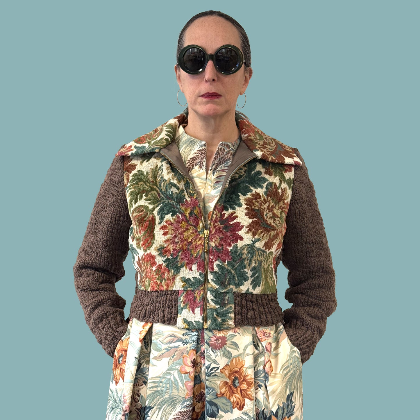 Ladies cropped jacket with vintage floral upholstery fabric front and hand knitted wool sleeves and back, torso view with zipper partially open