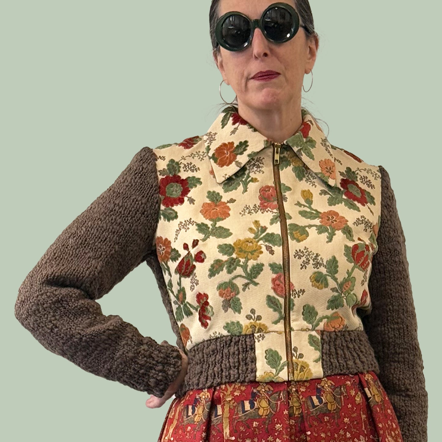 Ladies cropped jacket with vintage upholstery fabric front and hand knitted wool sleeves and back, front view with zipper closed